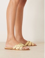‌Stylish studded flat sandals in butter yellow